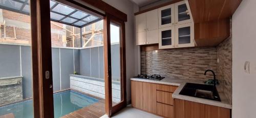 a kitchen with a sink and a swimming pool at Emerald Villa in Prampuan
