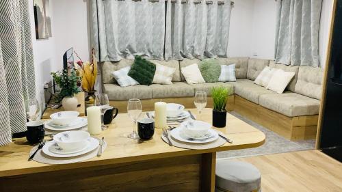 a living room with a table and a couch at BAF Luxury Stays - Billing Aquadrome - Caravan Sleeps 8 in Great Billing