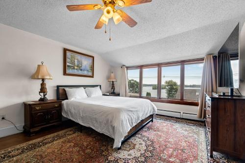 a bedroom with a bed and a ceiling fan at Grammy's Famous Lake House Retreat in East Hampton