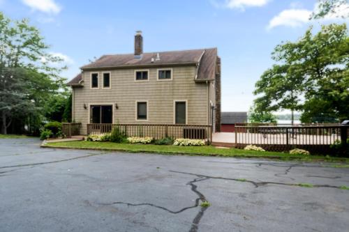 an empty parking lot in front of a house at Grammy's Famous Lake House Retreat in East Hampton
