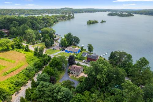 an aerial view of a house on the shore of a lake at Grammy's Famous Lake House Retreat in East Hampton