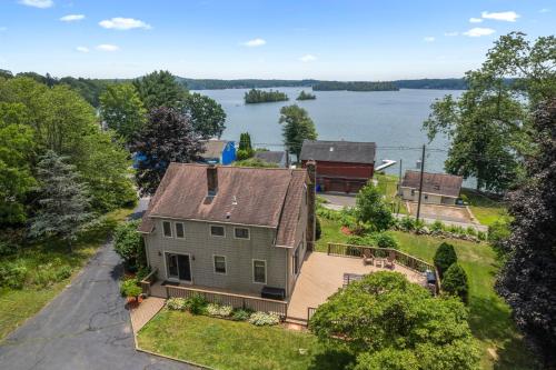 an aerial view of a house with a view of the water at Grammy's Famous Lake House Retreat in East Hampton