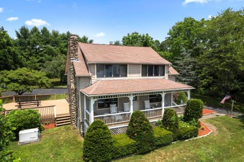 an aerial view of a house with a roof at Grammy's Famous Lake House Retreat in East Hampton