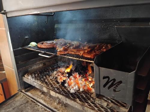 a grill with meat and other food on it at Heather Guest House in Alberton