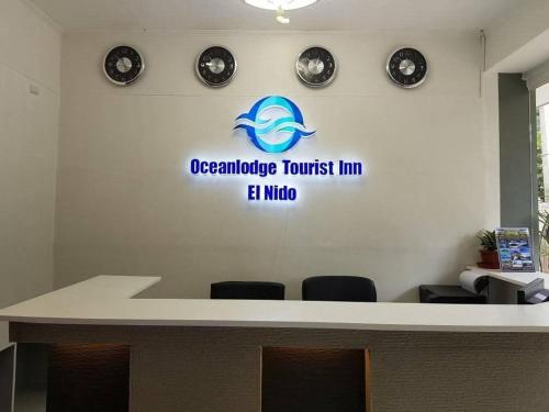 a sign for an oregonurance trust line on a wall at Oceanlodge Tourist Inn in El Nido
