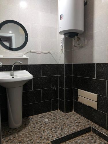 a bathroom with a sink and a mirror at Appartement en bord de mer 3 chambres in Aguemoun Taïda