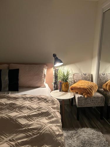 a bedroom with a bed and a table and a chair at Cozy Haven! in Edmonton