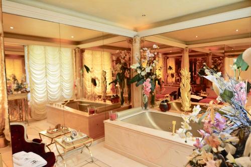 a large bathroom with a tub and a sink at 21a Maréchal FOCH Avenue Paris CHAMPS-ELYSÉES in Paris