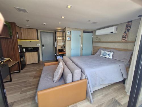 a bedroom with a bed and a couch at Frente Mar de Cabo Branco - Setai Edition in João Pessoa