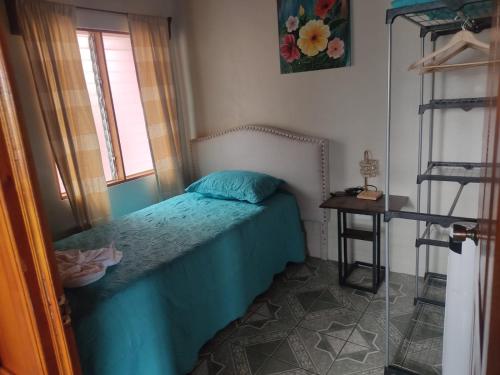 a small bedroom with a bed and a window at Departamento Ángeles del Arenal #1 in Fortuna