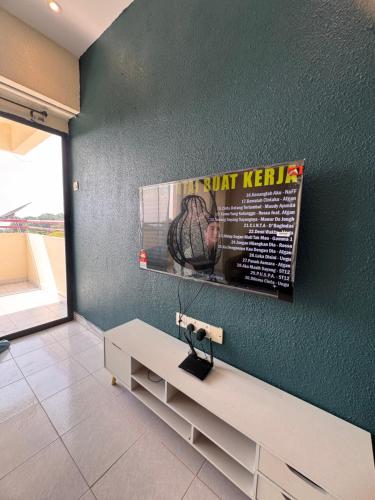 a living room with a bench and a poster on the wall at Sri Sayang sunset 2 bedroom in Batu Ferringhi