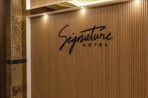 a sign on a wall in a hotel room at Signature Tourist Hotel in Seoul