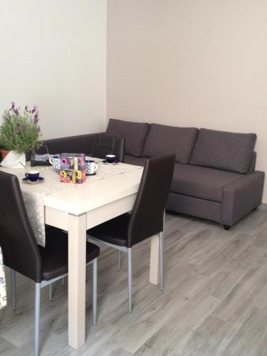 a living room with a table and a couch at Sweet Holiday Home in Bernalda