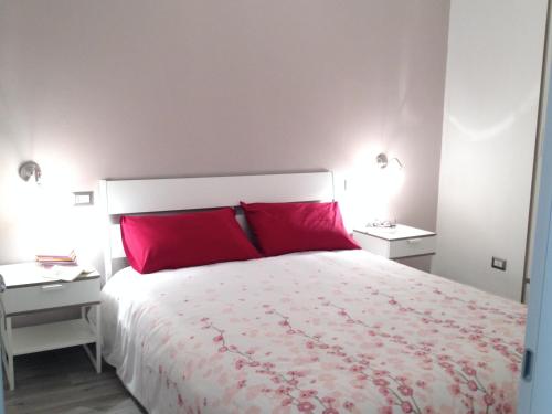 a bedroom with two red pillows on a bed at Sweet Holiday Home in Bernalda