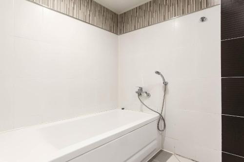 a bathroom with a bath tub and a shower at Signature Tourist Hotel in Seoul