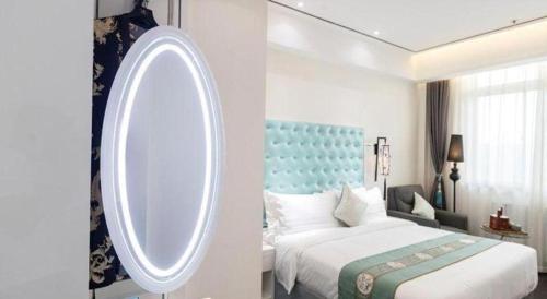 a bedroom with a bed and a round mirror at Xana Hotelle Xi'an GONG IP South Gate of Zhonglou in Xi'an