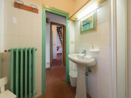 a bathroom with a sink and a toilet and a mirror at Rustic Chalet with Pool in San Marcello Pistoiese
