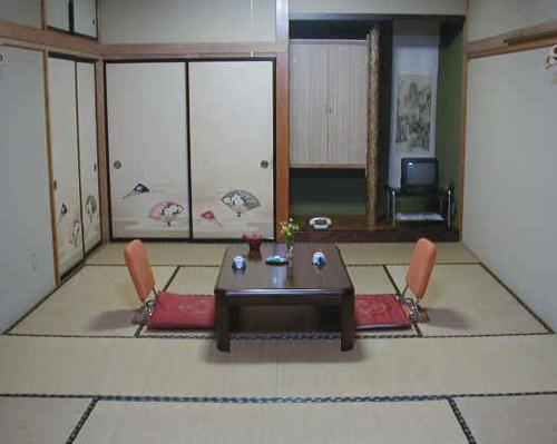 a dining room with a table and two chairs at Resort Inn Fujihashi in Fujikawaguchiko