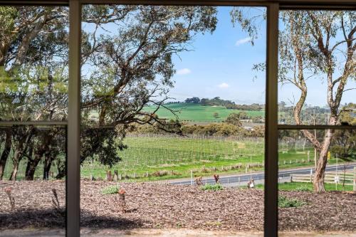 a view from a window of a vineyard at Ultima Escapes - Carcoola House - Barossa Fringe Retreat in Greenock