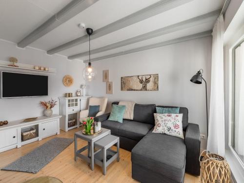 a living room with a couch and a tv at Garden Comfort in Rieder, Harz in Ballenstedt