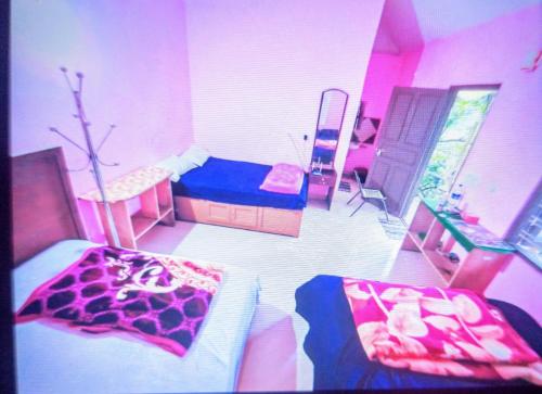 a room with two beds and a room with a giraffe at Green porticos villa munnar #MUNNAR in Anachal