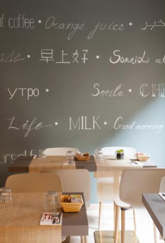 a chalkboard wall with writing on it in a restaurant at Hotel Ares Milano in Milan