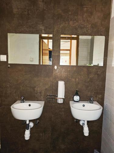 a bathroom with two sinks and a mirror at hostel Toper in Celje