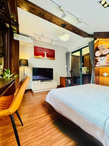 a bedroom with a large bed and a flat screen tv at Homestay My Ny Đà Lạt in Khu Chi Lăng