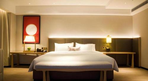Ένα ή περισσότερα κρεβάτια σε δωμάτιο στο Echeng Hotel Enshi Minzu Road