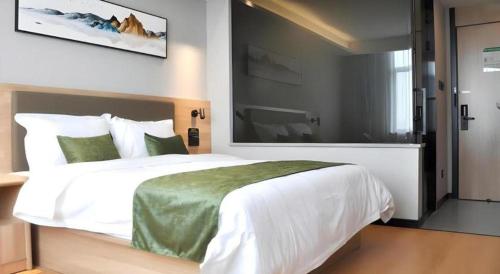 Ένα ή περισσότερα κρεβάτια σε δωμάτιο στο Green Tree Inn Anhui Tianchang Economic Development Zone