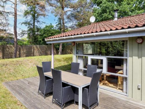 a patio with a wooden table and chairs at 6 person holiday home in Hadsund-By Traum in Øster Hurup