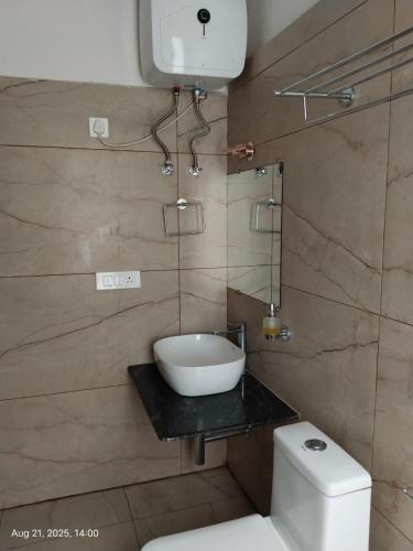 a bathroom with a toilet and a bowl on a counter at Hotel Swastik Inn in Gangtok