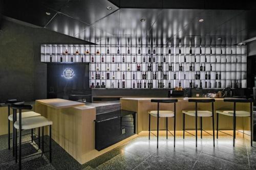 a bar in a restaurant with bar stools at Airfeel Hotel in Ziyang