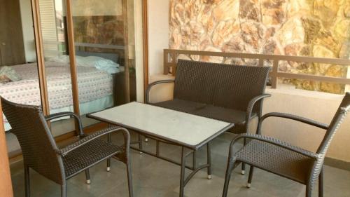 a table and chairs in a room with a bed at Departamento Costa Pucon in Pucón