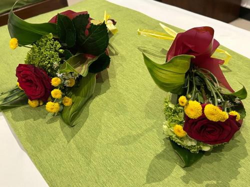 two bouquets of flowers sitting on a table at Jaffna City Palace Hotel in Jaffna