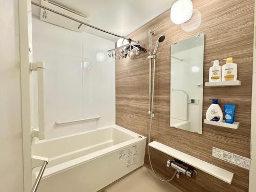 a bathroom with a shower and a tub and a sink at 北沢愛の旅 in Tokyo