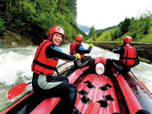 a group of people in a raft on a river at Holiday Home in Scheifling near Ski Slopes in Scheifling