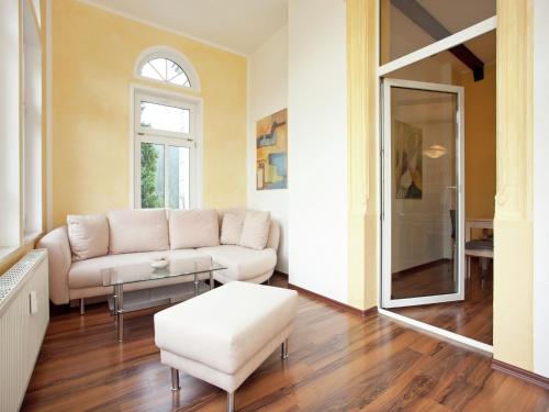 a living room with a couch and a table at Elegant Villa in Borstendorf in Grünhainichen