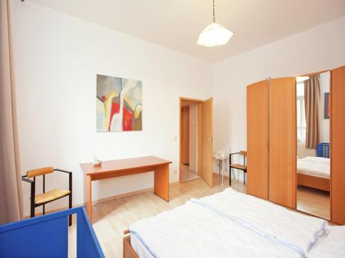 a bedroom with a bed and a table and a desk at Elegant Villa in Borstendorf in Grünhainichen
