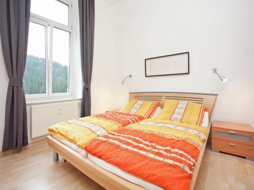 a bedroom with a bed and a large window at Elegant Villa in Borstendorf in Grünhainichen