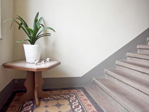 a potted plant sitting on a table next to stairs at Elegant Villa in Borstendorf in Grünhainichen