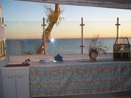 a kitchen with a view of the ocean at Villa Mare Di Montelusa in Agrigento