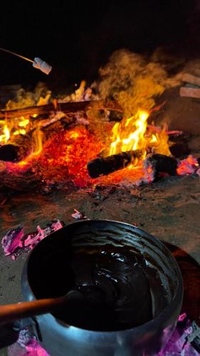 a fire with a pot in front of it at Ecocamping Okaeté in Buíque