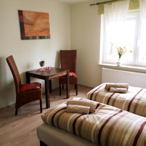 a bedroom with two beds and a table and chairs at Ferienhaus Brit in Albstadt