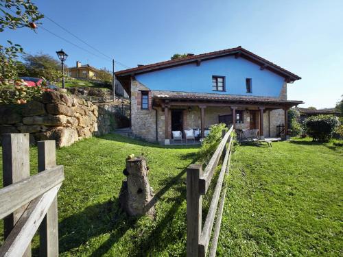 a house with a fence in front of it at Cozy Cottage with Pool & Terrace in Nava