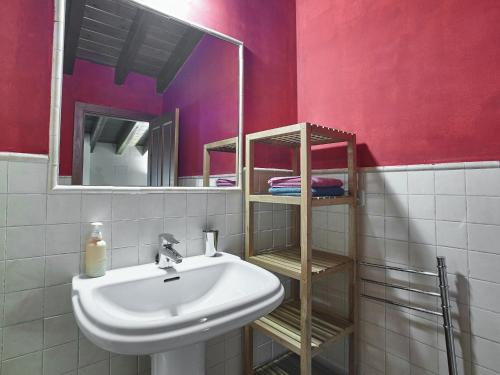 a bathroom with a sink and a mirror at Cozy Cottage with Pool & Terrace in Nava