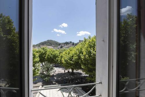 an open window with a view of a courtyard at Hotel Burrhus in Vaison-la-Romaine