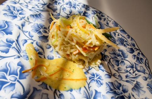a blue and white plate with noodles and vegetables at Hotel Luis in Fiera di Primiero