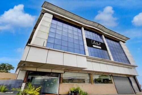 a building with a sign on the side of it at Collection O Infopark Kochi Formerly Malabar Plaza Residency in Kakkanad