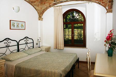 a bedroom with a large bed and a window at Residence Bizzoni in Terni